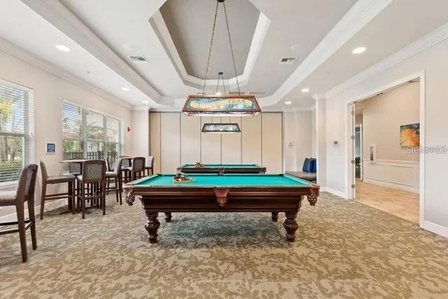 a room with pool tables and windows