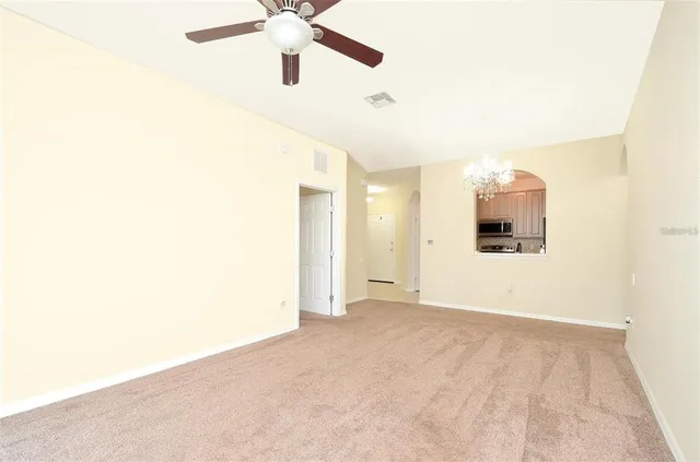 a view of a big room with wooden floor and windows in a room