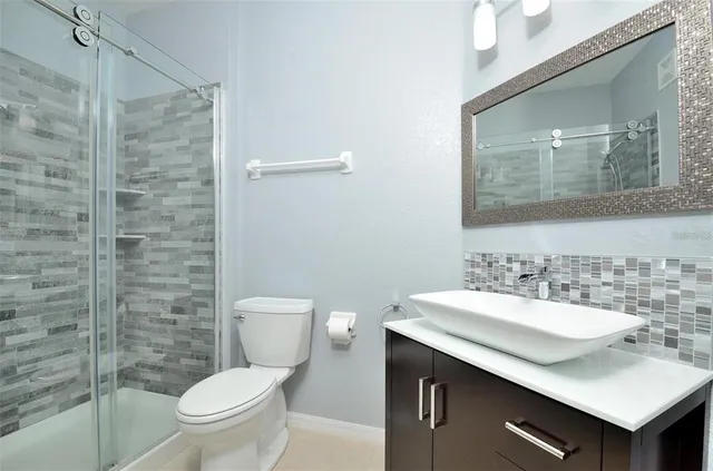 a bathroom with a sink toilet and mirror