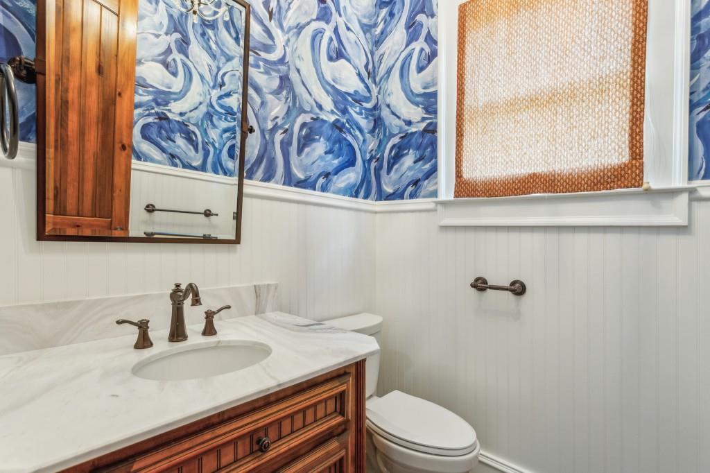 1363 Sylvan Circle Northeast Brookhaven, GA 30319 - Photo 32 of 56 a bathroom with a granite countertop sink and a toilet