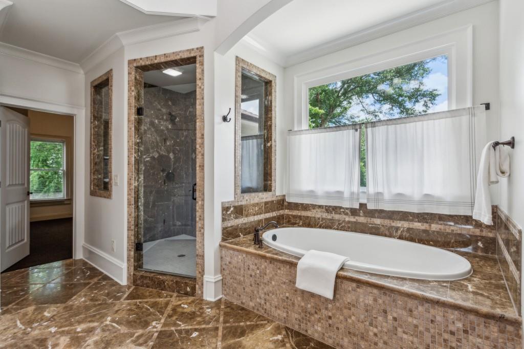 1363 Sylvan Circle Northeast Brookhaven, GA 30319 - Photo 37 of 56 a bathroom with a granite countertop tub sink and mirror