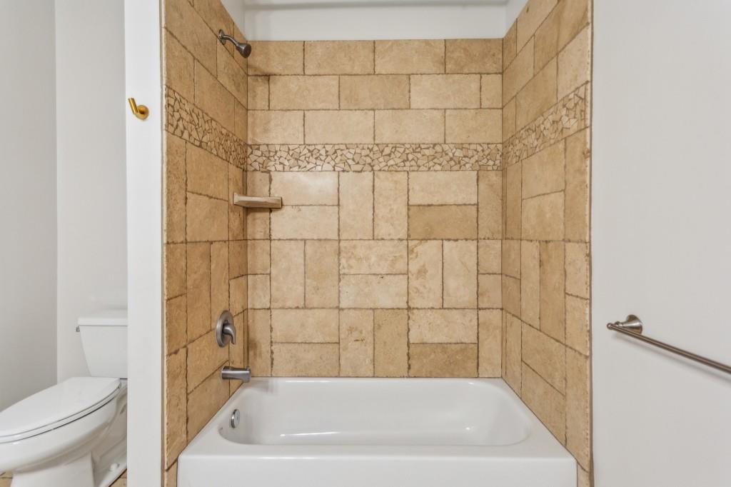 1363 Sylvan Circle Northeast Brookhaven, GA 30319 - Photo 42 of 56 a bathroom with a bathtub and a toilet