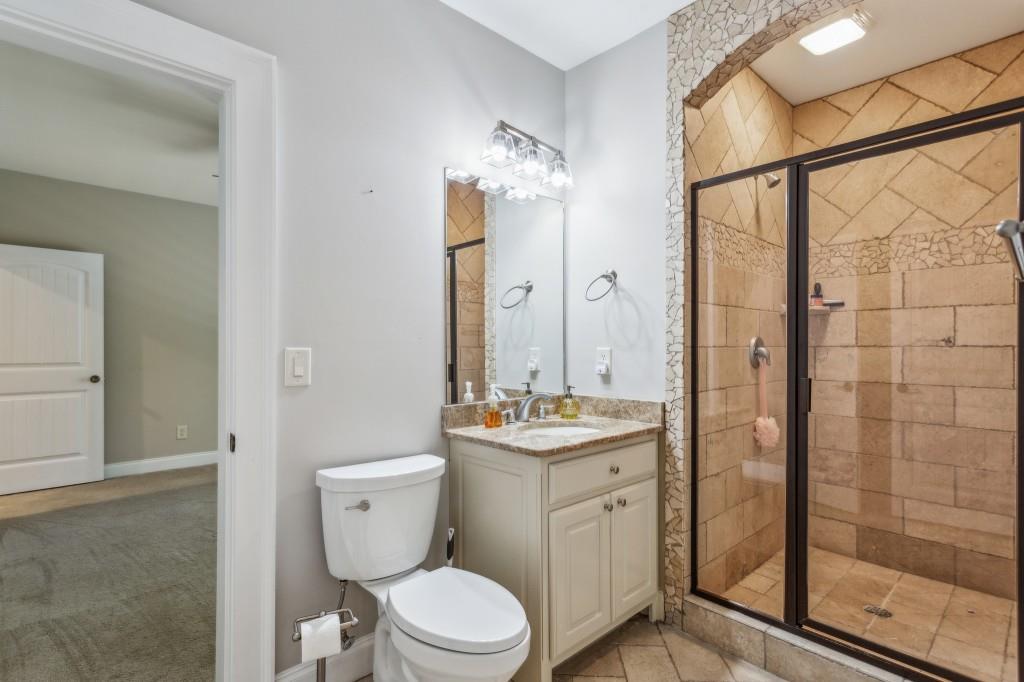 1363 Sylvan Circle Northeast Brookhaven, GA 30319 - Photo 52 of 56 a bathroom with a toilet sink vanity and mirror