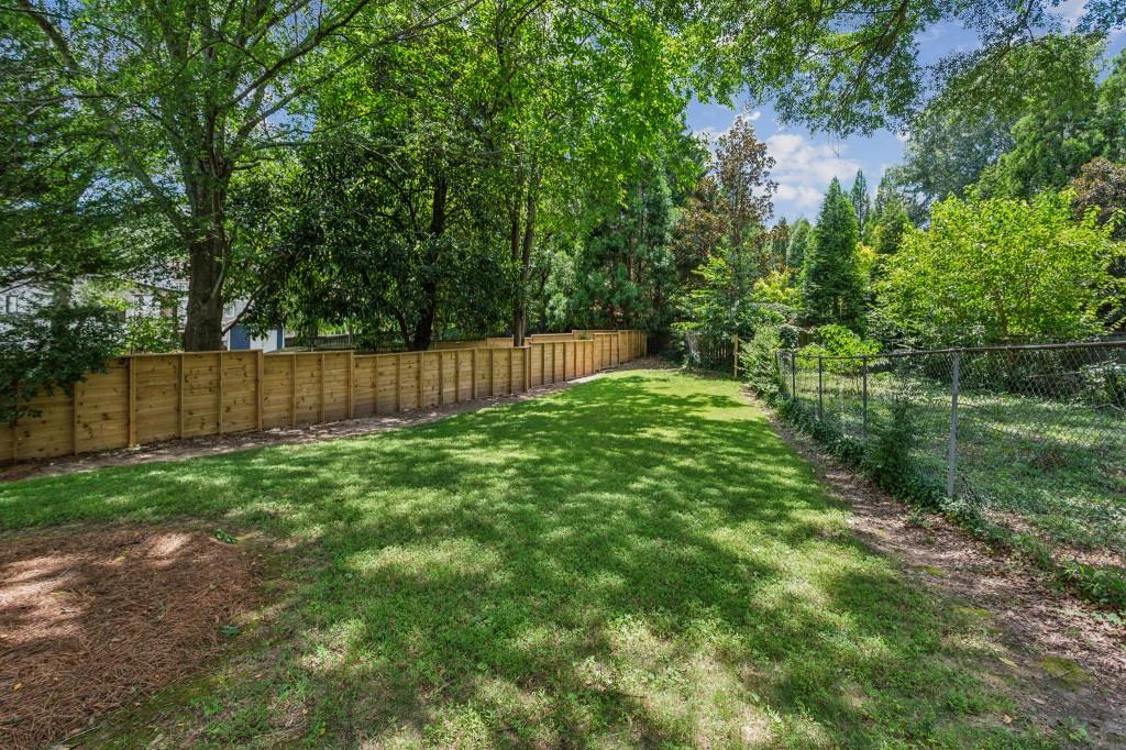 1363 Sylvan Circle Northeast Brookhaven, GA 30319 - Photo 7 of 56 a view of a yard with large trees and wooden fence