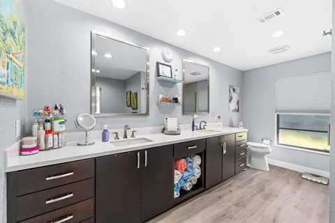 a spacious bathroom with a double vanity sink and a mirror