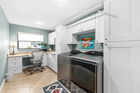 a view of a kitchen with fridge and workspace