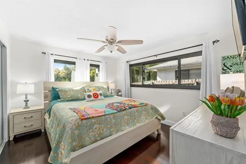 a bedroom with a bed and a potted plant