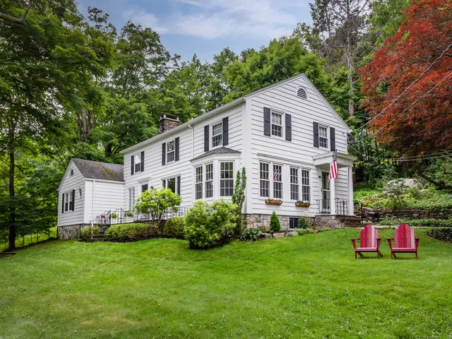a aerial view of a house with backyard and garden