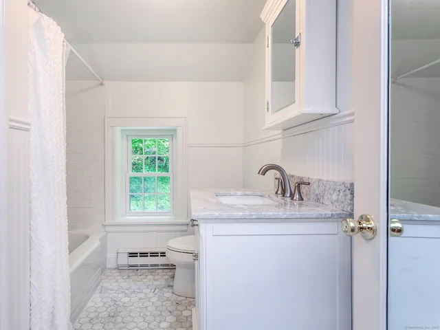 a bathroom with a sink and a window