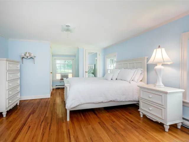 a bedroom with a bed and a view of kitchen