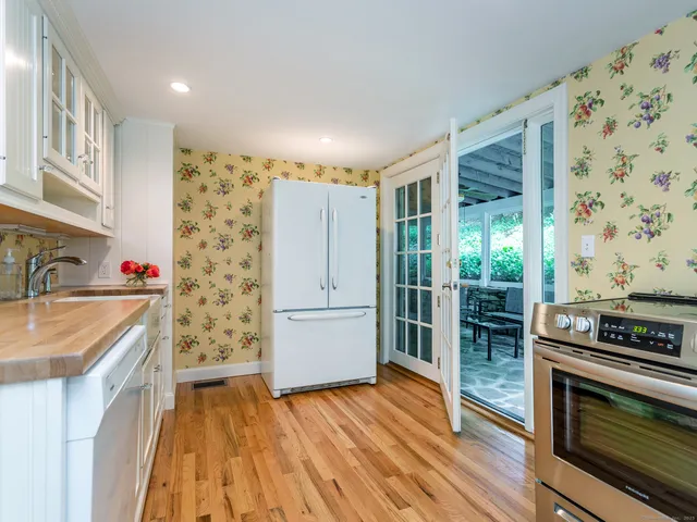 a kitchen with stainless steel appliances granite countertop a refrigerator and a stove top oven