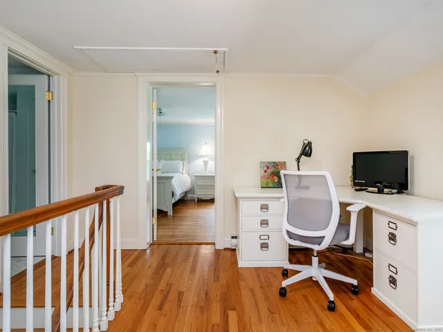a room with a chair and a flat screen tv