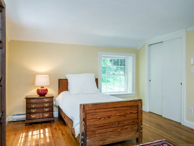 a bedroom with a bed and a window