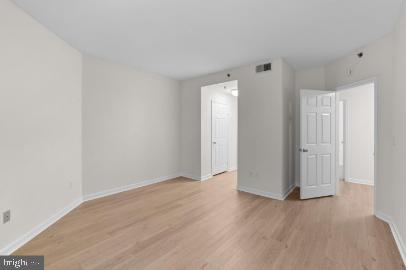 960 Fell Street, Unit 402 Baltimore, MD 21231 - Photo 14 of 18 a view of an empty room with wooden floor