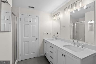 960 Fell Street, Unit 402 Baltimore, MD 21231 - Photo 16 of 18 a bathroom with double vanity sinks and a mirror