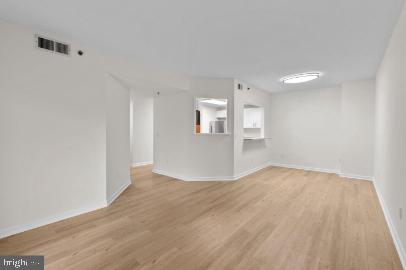 960 Fell Street, Unit 402 Baltimore, MD 21231 - Photo 7 of 18 a view of an empty room with wooden floor