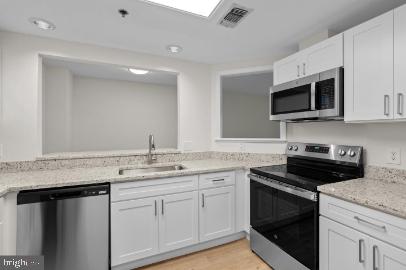 960 Fell Street, Unit 402 Baltimore, MD 21231 - Photo 8 of 18 a kitchen with a sink stove and microwave