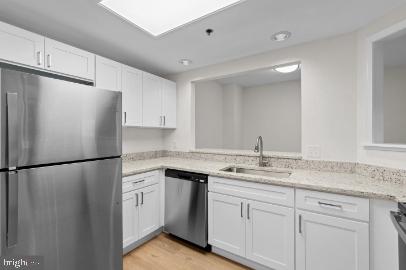 960 Fell Street, Unit 402 Baltimore, MD 21231 - Photo 9 of 18 a white refrigerator freezer sitting inside of a kitchen