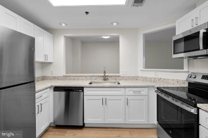 960 Fell Street, Unit 402 Baltimore, MD 21231 - Photo 10 of 18 a kitchen with a sink stove and microwave