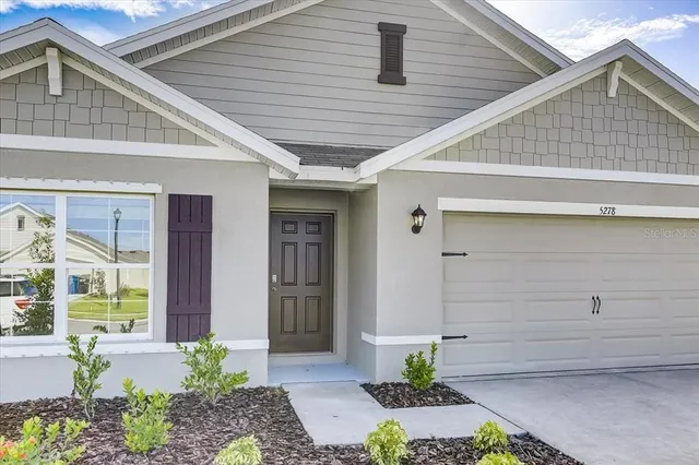a front view of a house with a garage