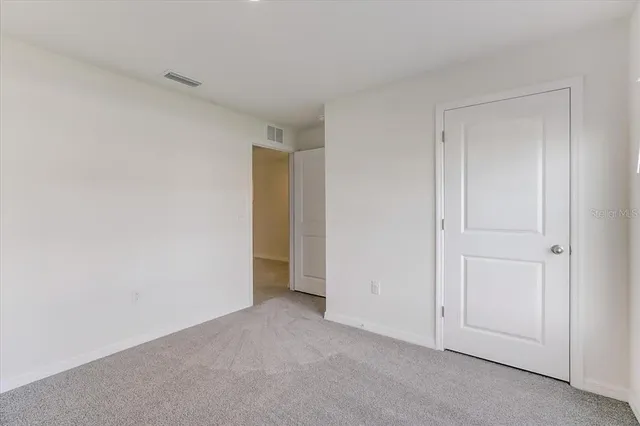 a view of an empty room and entryway