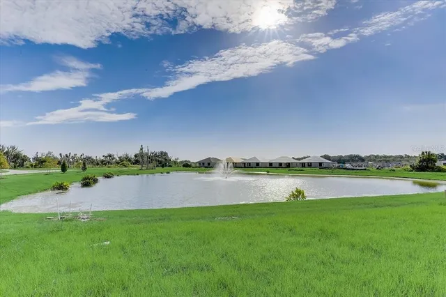 a view of a lake with houses in the back