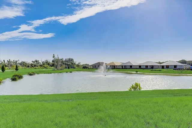 a view of a lake with houses in the back