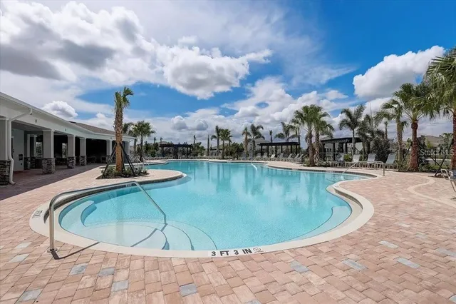 a view of a swimming pool in back of house
