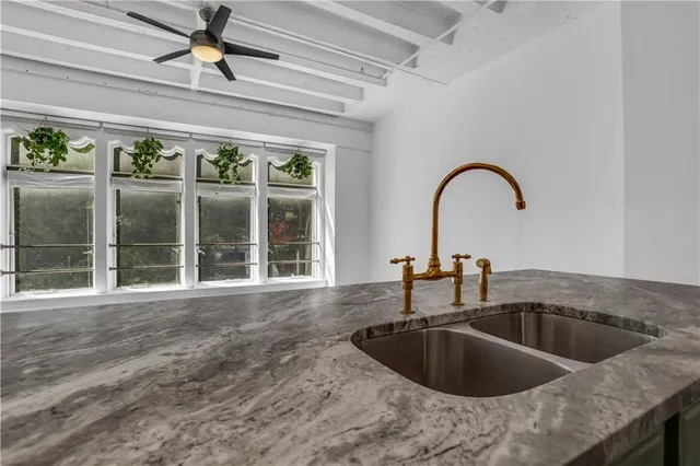 a kitchen with a sink and a large window