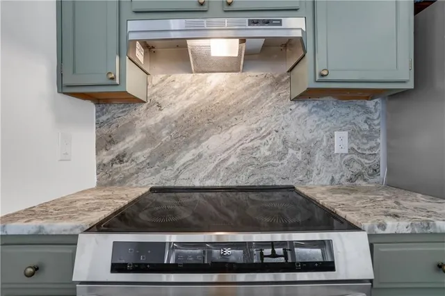 a stove top oven sitting inside of a kitchen