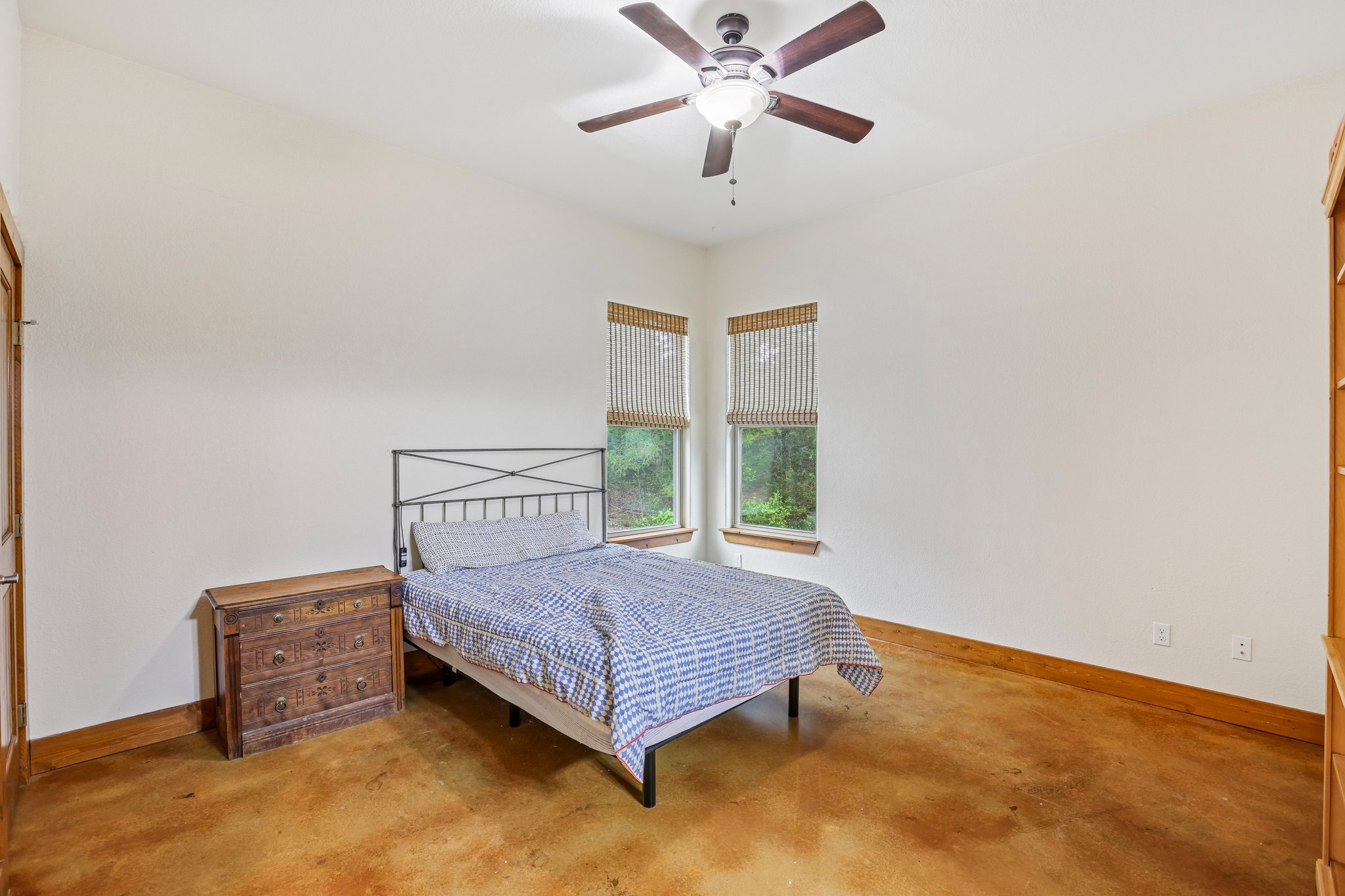 267 Corral Road Smithville, TX 78957 - Photo 20 of 40 Room featuring stained concrete flooring, white walls, and a ceiling fan with integrated lighting