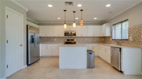 a kitchen with cabinets and window