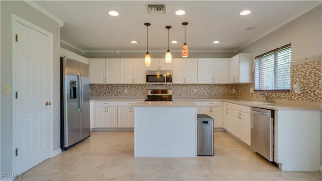 a kitchen with cabinets and window