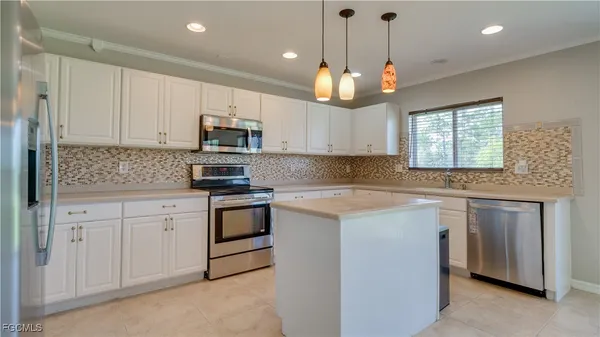 a kitchen with stainless steel appliances granite countertop a stove sink and microwave