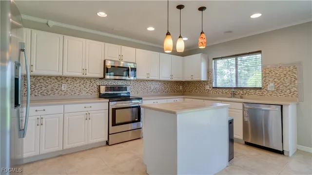 a kitchen with stainless steel appliances granite countertop a stove sink and microwave