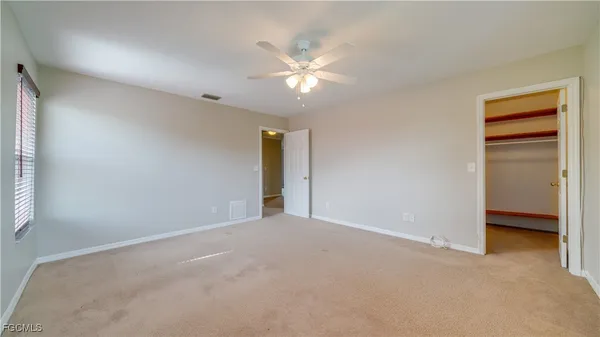 a view of an empty room with a ceiling fan