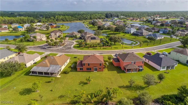 an aerial view of residential houses with outdoor space and swimming pool