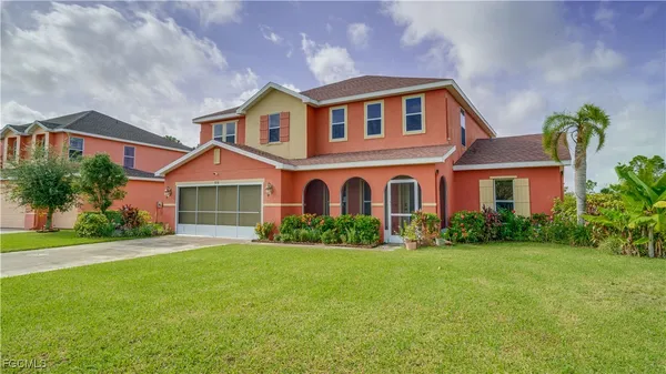 a front view of a house with garden