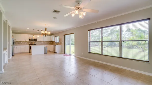 a view of a kitchen with furniture and a large window