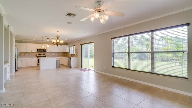 a view of a kitchen with furniture and a large window