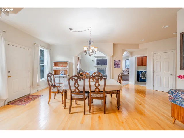 a dining room with furniture and wooden floor