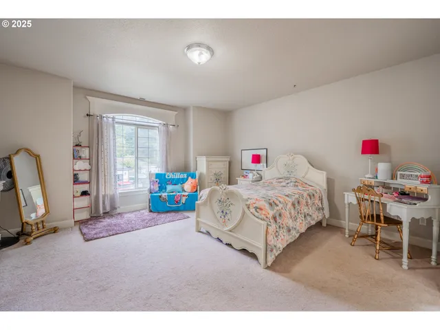 a bedroom with a bed a desk and chair