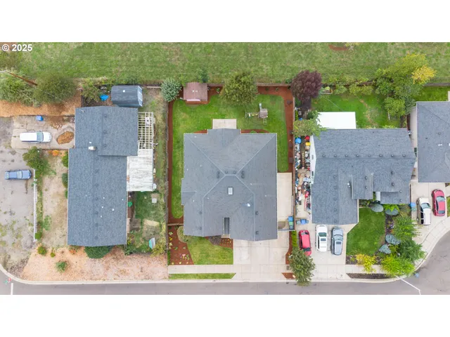 an aerial view of a house with a garden and a yard