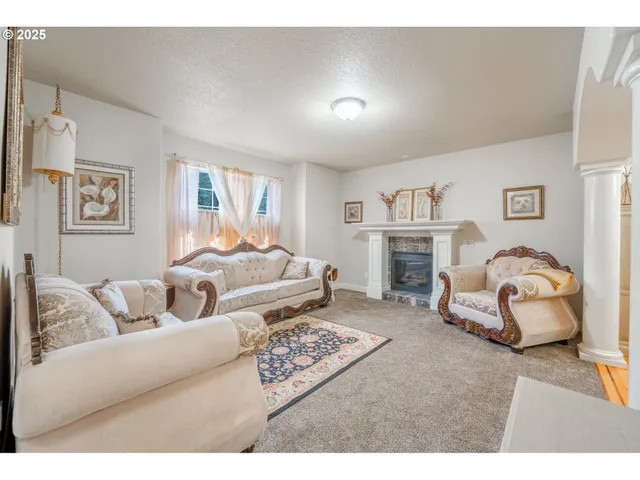 a living room with furniture and a fireplace