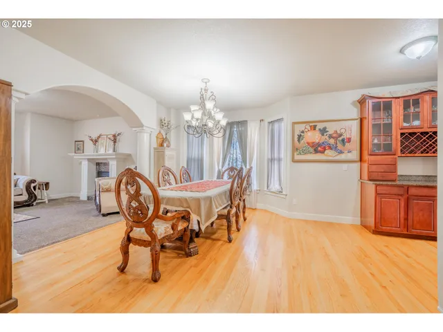 a view of a dining room with furniture and chandelier