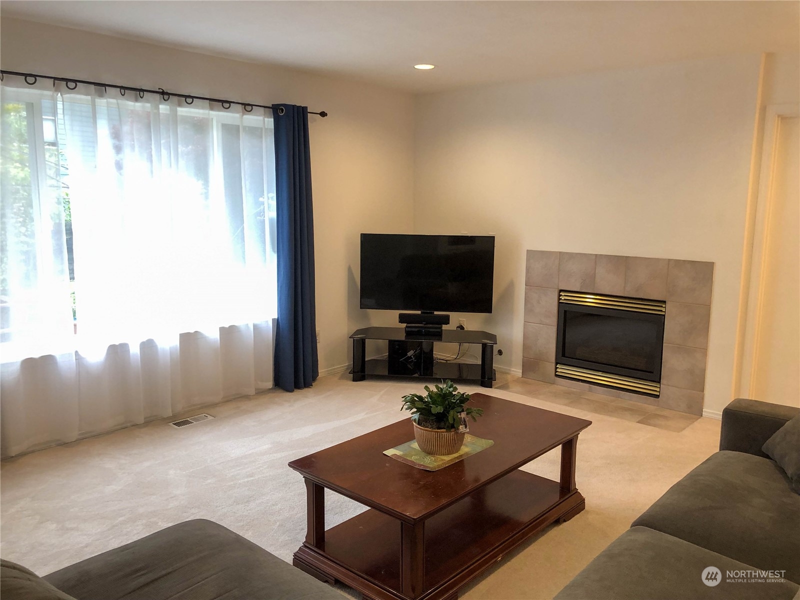 4302 Northeast 6th Place Renton, WA 98059 - Photo 11 of 20 a living room with furniture and a flat screen tv