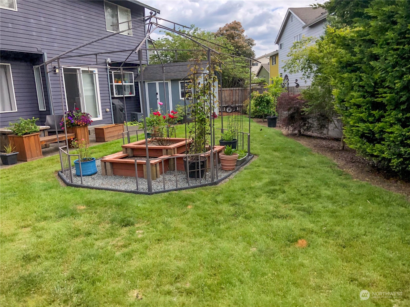 4302 Northeast 6th Place Renton, WA 98059 - Photo 3 of 20 a view of a house with backyard sitting area and garden