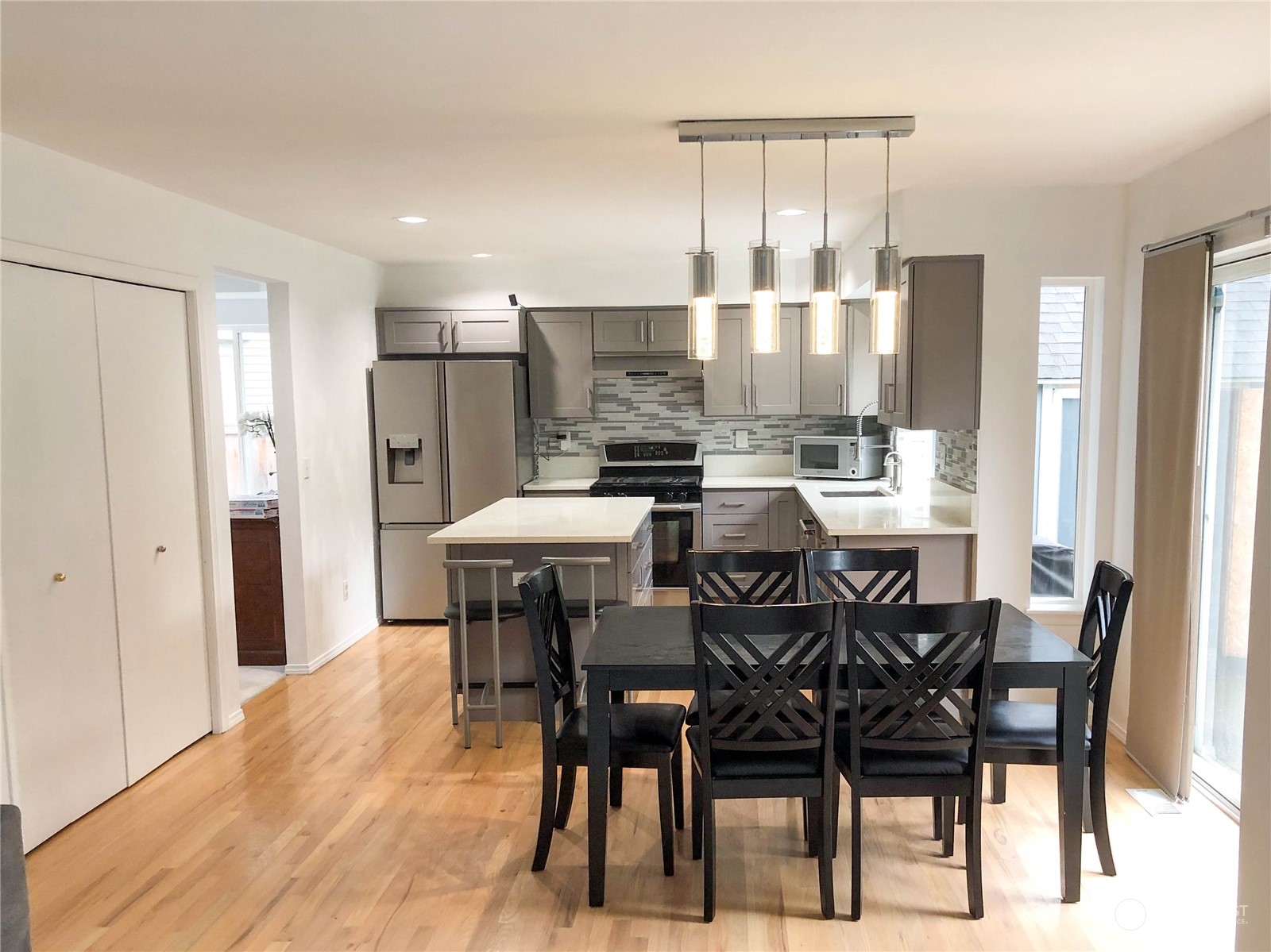 4302 Northeast 6th Place Renton, WA 98059 - Photo 8 of 20 a view of a dining room and livingroom with furniture wooden floor a chandelier