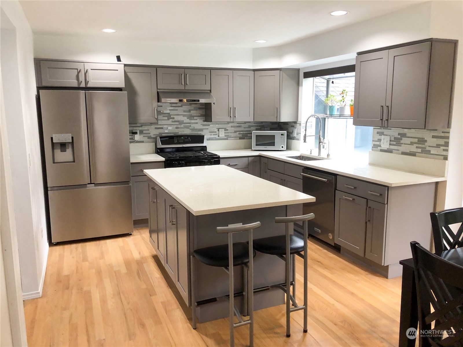4302 Northeast 6th Place Renton, WA 98059 - Photo 9 of 20 a kitchen with stainless steel appliances a refrigerator a stove a sink and a refrigerator