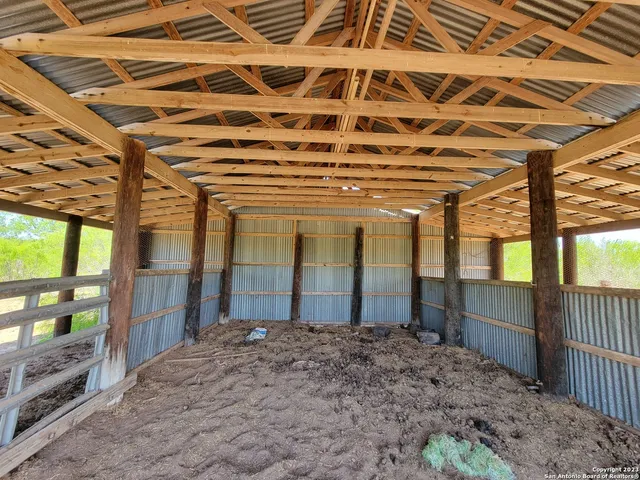 a view of a dry yard with trees